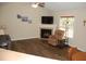 Warm living room featuring a fireplace, ceiling fan, and comfortable seating area at 3145 Pier Pointe Dr, Creedmoor, NC 27522
