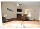 Cozy living room with fireplace, ceiling fan, and wood-look flooring at 3145 Pier Pointe Dr, Creedmoor, NC 27522
