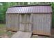 Backyard shed with weathered wood and metal roof at 3145 Pier Pointe Dr, Creedmoor, NC 27522