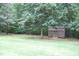Backyard shed surrounded by mature trees and lawn at 3145 Pier Pointe Dr, Creedmoor, NC 27522