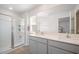 Bright bathroom featuring a double vanity with stone counters and a glass-enclosed shower at 316 Mimosa Ct, Sanford, NC 27332