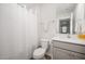 Clean bathroom with a combination tub and shower, white vanity, and neutral decor at 316 Mimosa Ct, Sanford, NC 27332