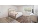 Bright bedroom with a stylish bed, decorative rug, and a view of the outdoors through the window at 316 Mimosa Ct, Sanford, NC 27332