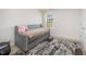 Comfortable bedroom with a daybed, soft textures, and a stylish patterned rug at 316 Mimosa Ct, Sanford, NC 27332
