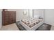 Cozy bedroom showcasing a tufted headboard, patterned quilt, and rich dark wood dresser at 316 Mimosa Ct, Sanford, NC 27332