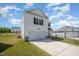 Side angle shot of a two-story home with white siding, an attached garage, and spacious lot at 316 Mimosa Ct, Sanford, NC 27332