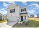 Traditional two-story home featuring white siding, black shutters, and an attached garage with concrete driveway at 316 Mimosa Ct, Sanford, NC 27332