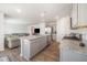 Open-concept kitchen featuring gray cabinets, stainless steel appliances, and a granite countertop island at 316 Mimosa Ct, Sanford, NC 27332