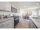 Modern kitchen with granite countertops, stainless steel appliances, and an open layout at 316 Mimosa Ct, Sanford, NC 27332