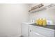 Well-lit laundry room equipped with a washer, dryer, and convenient overhead storage shelf at 316 Mimosa Ct, Sanford, NC 27332
