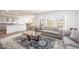 Bright and airy living room with stylish furniture, large windows, and open view to the kitchen at 316 Mimosa Ct, Sanford, NC 27332