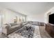 Spacious living room showcasing elegant sofas, a decorative rug, and an open floor plan at 316 Mimosa Ct, Sanford, NC 27332