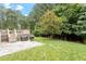Lush backyard with a spacious deck, stone patio, mature trees, and plenty of room for outdoor activities at 3217 Ranbir Dr, Durham, NC 27713