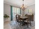 A formal dining area with a chandelier, wooden table and chairs, and natural light at 3217 Ranbir Dr, Durham, NC 27713