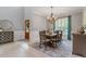 Bright dining room features an elegant chandelier, stylish rug, and a light-filled window at 3217 Ranbir Dr, Durham, NC 27713