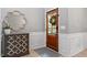 Elegant entryway with stylish console table, decorative mirror, and a welcoming front door at 3217 Ranbir Dr, Durham, NC 27713