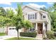 Charming two-story home features a stone facade, well-manicured lawn, and a two-car garage at 3217 Ranbir Dr, Durham, NC 27713