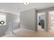 Upstairs hallway leading to bedrooms, naturally lit with neutral walls and plush carpeting at 3217 Ranbir Dr, Durham, NC 27713