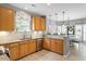 Well-equipped kitchen with marble countertops, wooden cabinets, and stainless steel sink at 3217 Ranbir Dr, Durham, NC 27713