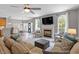 Open-concept living area with fireplace, large windows, and access to kitchen and dining at 3217 Ranbir Dr, Durham, NC 27713
