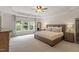 Spacious main bedroom featuring large windows, tray ceiling, and a comfortable, neutral color scheme at 3217 Ranbir Dr, Durham, NC 27713