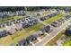 A high-angle perspective captures the residential layout with homes, streets, and a community pool area at 3421 Lebrun Path, Fuquay Varina, NC 27526