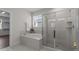 Bright bathroom featuring a soaking tub, glass shower, and a window to enjoy natural light at 3421 Lebrun Path, Fuquay Varina, NC 27526