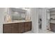 Elegant bathroom features a double vanity, large mirror, and a separate toilet room for added privacy at 3421 Lebrun Path, Fuquay Varina, NC 27526