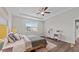 Cozy bedroom with a tray ceiling, a large window, and modern decor creates a tranquil ambiance at 3421 Lebrun Path, Fuquay Varina, NC 27526