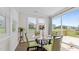 Cozy breakfast nook with a round table, green chairs, and sliding glass doors leading to the outside deck at 3421 Lebrun Path, Fuquay Varina, NC 27526