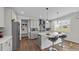 Bright kitchen with a large island, bar seating, stainless steel appliances, and a convenient mudroom area at 3421 Lebrun Path, Fuquay Varina, NC 27526
