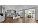 Modern kitchen featuring an island with seating, stainless steel appliances, and an adjacent dining area at 3421 Lebrun Path, Fuquay Varina, NC 27526
