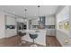 Modern kitchen featuring a large island, stylish pendant lighting, stainless steel appliances, and elegant blue backsplash at 3421 Lebrun Path, Fuquay Varina, NC 27526