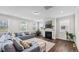 Inviting living room featuring a fireplace, hardwood floors, and a large sectional sofa at 3421 Lebrun Path, Fuquay Varina, NC 27526