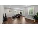 Relaxing living room featuring a leather sofa and large windows for natural light at 3421 Lebrun Path, Fuquay Varina, NC 27526