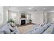 Spacious living room with fireplace, hardwood floors, and a comfortable sectional sofa at 3421 Lebrun Path, Fuquay Varina, NC 27526