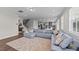 Open-concept living room flowing into the kitchen with a large sectional and hardwood floors at 3421 Lebrun Path, Fuquay Varina, NC 27526