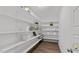 Spacious walk-in pantry with ample shelving for organized storage of groceries and household supplies at 3421 Lebrun Path, Fuquay Varina, NC 27526