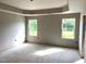 A bedroom with a tray ceiling and large windows at 35 Windflower Court Ct # Homesite 9, Clayton, NC 27520