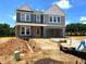 Two-story home featuring gray siding, white trim, covered porch, and an attached garage at 35 Windflower Court Ct # Homesite 9, Clayton, NC 27520