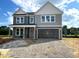 Two-story home with gray siding, white trim, attached two-car garage, and covered porch at 35 Windflower Ct # Homesite 9, Clayton, NC 27520