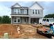 Two-story house with gray siding and white trim during the construction phase showing the front and the bare ground at 35 Windflower Court Ct # Homesite 9, Clayton, NC 27520