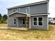 View of the back of the two-story house with gray siding and white trim at 35 Windflower Court Ct # Homesite 9, Clayton, NC 27520