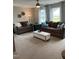 Bright living room boasts two couches, an ottoman, blue accents, and lots of natural light at 35 Windflower Court Ct # Homesite 9, Clayton, NC 27520