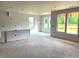 Unfinished living room shows bare walls and concrete floors with large windows at 35 Windflower Court Ct # Homesite 9, Clayton, NC 27520