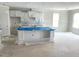 Unfinished kitchen with an island and white cabinets covered in plastic at 35 Windflower Ct # Homesite 9, Clayton, NC 27520