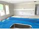 Unfinished kitchen area with plastic on the countertops and cabinets at 35 Windflower Ct # Homesite 9, Clayton, NC 27520