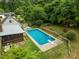 Aerial view of the backyard featuring a sparkling swimming pool, lush greenery, and inviting outdoor spaces at 3516 Swift Dr, Raleigh, NC 27606