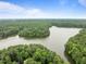 Breathtaking aerial view of the home surrounded by lush greenery and a serene lake at 3516 Swift Dr, Raleigh, NC 27606