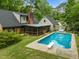 Large in-ground pool with a screened in porch area attached to the house at 3516 Swift Dr, Raleigh, NC 27606